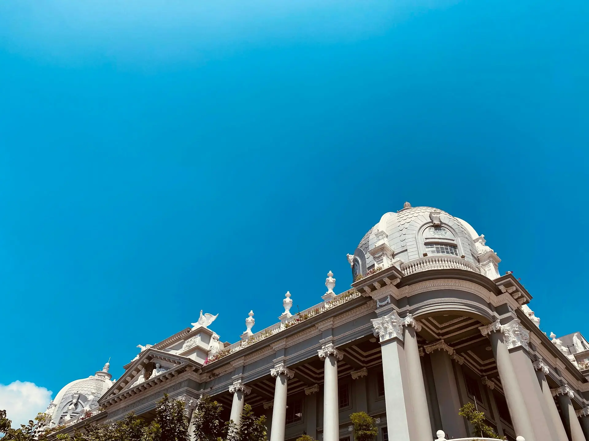 a large building with columns and statues on top of it